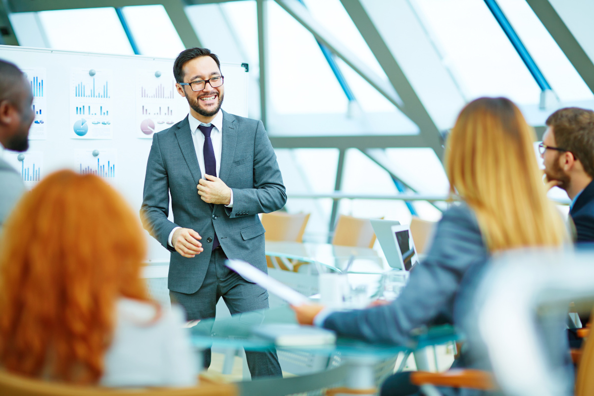 A group of employees in training with a happy trainer