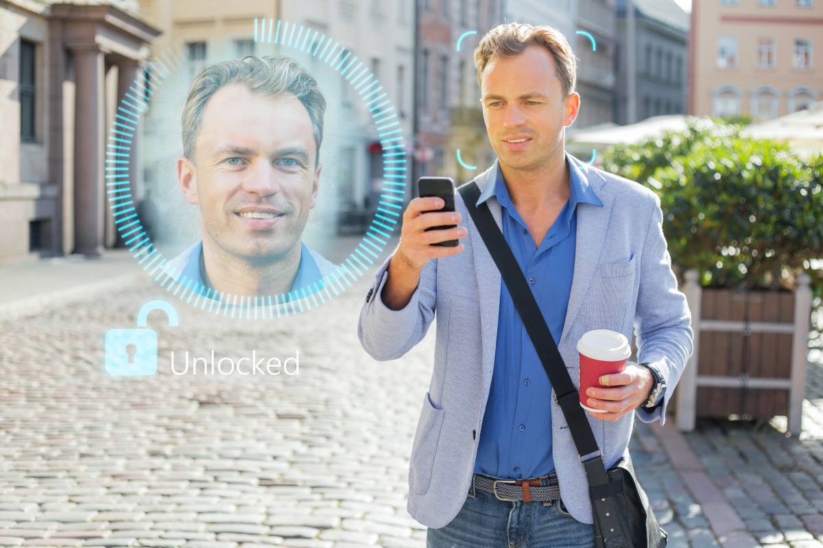 A person holding up their mobile phone for facial recognition
