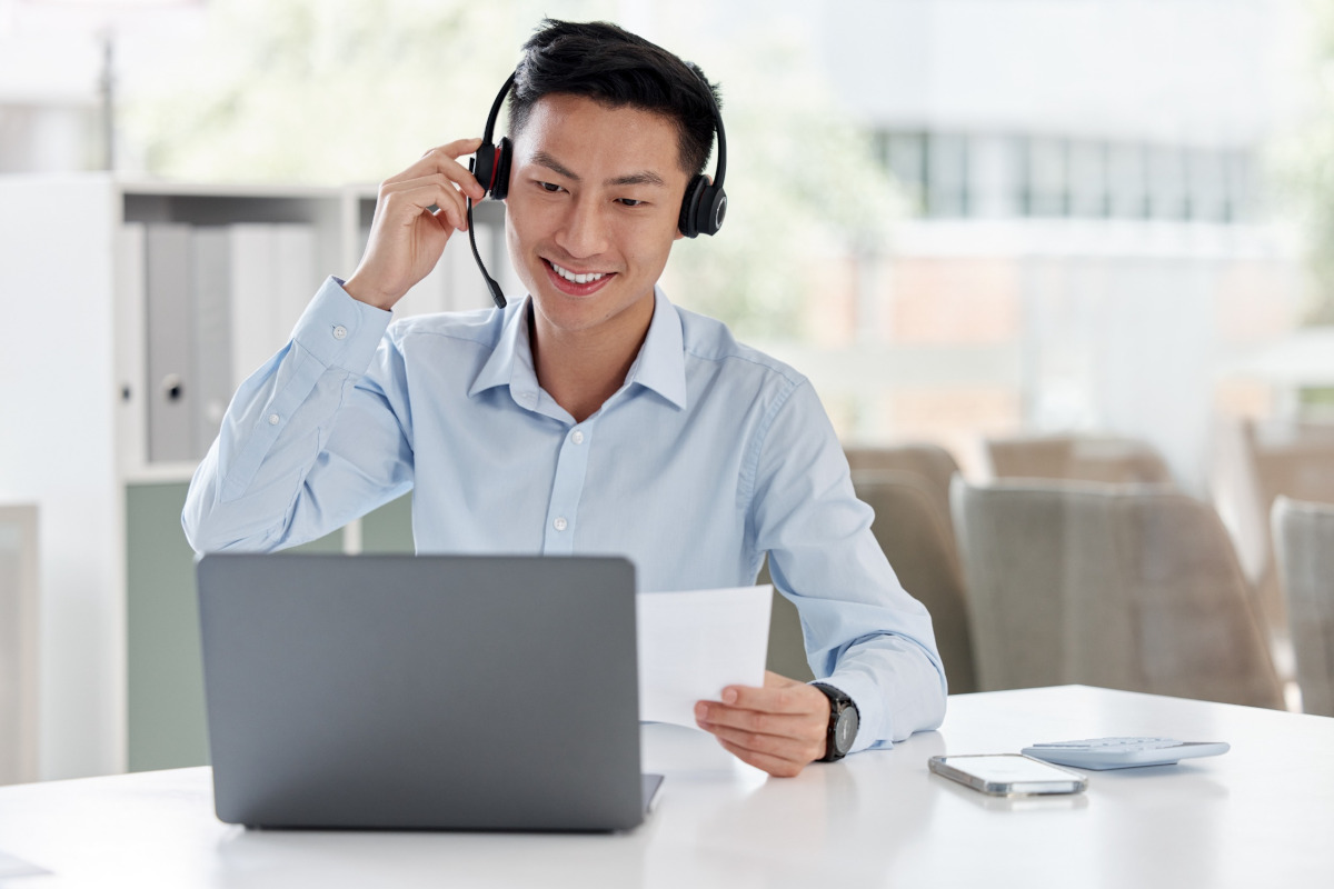 Man with headphones working on laptop
