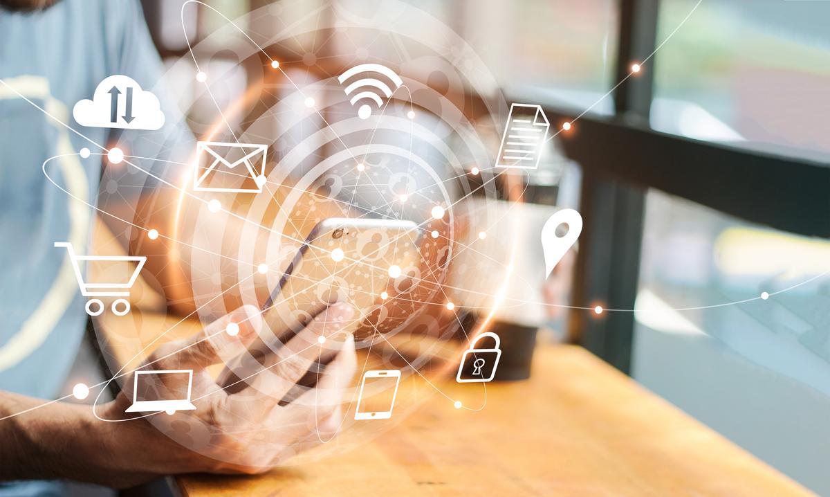 Man using phone with digital communications icons floating around
