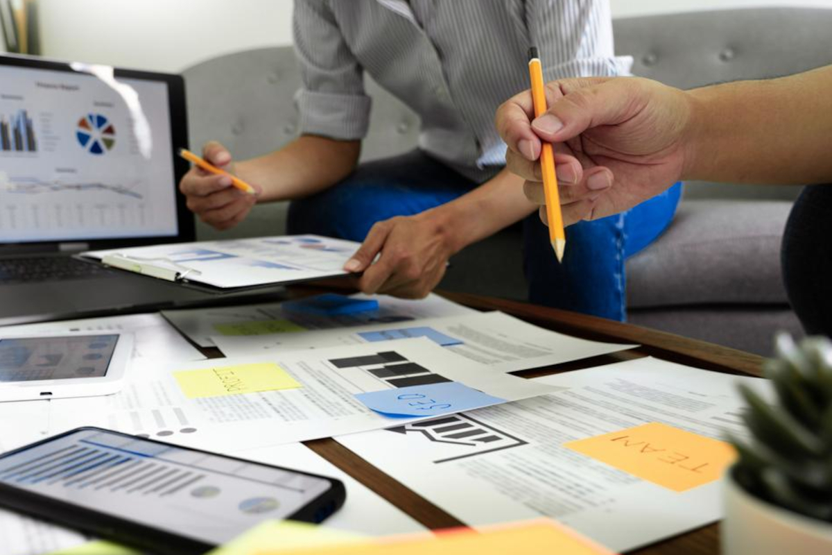 Two men going through documents on a desk